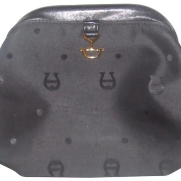 Etienne Aigner black logo design nylon and black leather, clutch or cosmetic bag with gold tone logo accents, a hinged opening