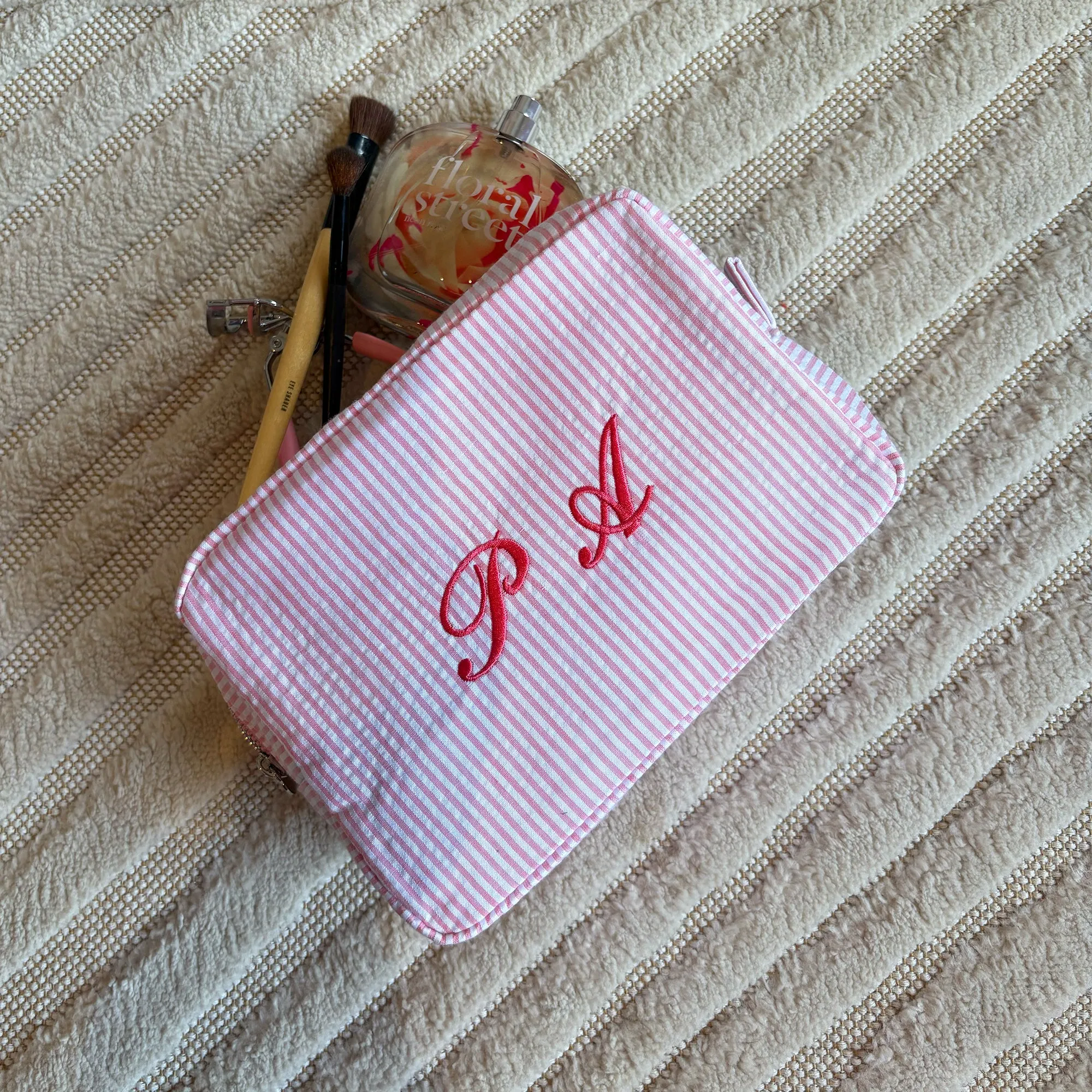 Monogramed stripe cosmetic bag