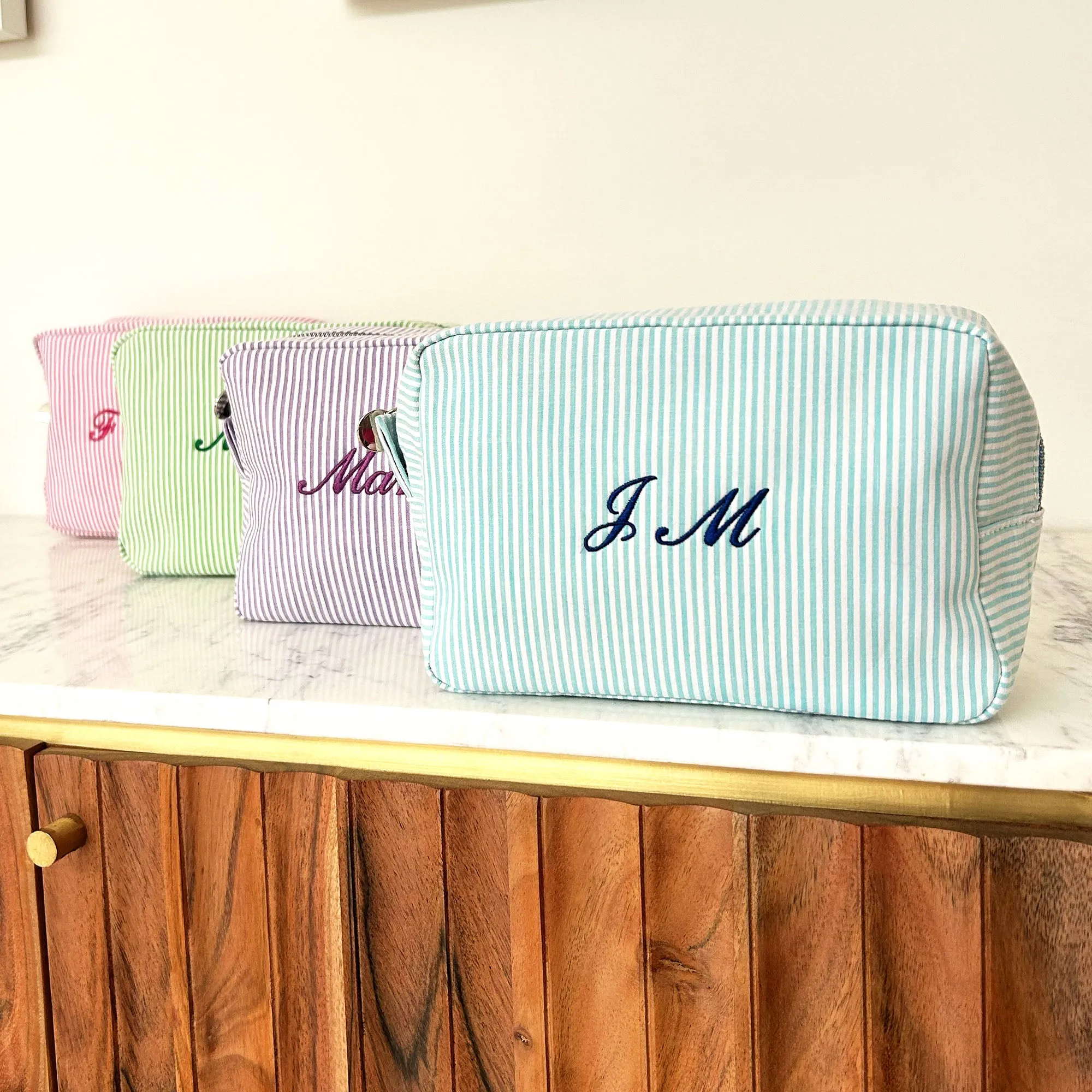 Monogramed stripe cosmetic bag